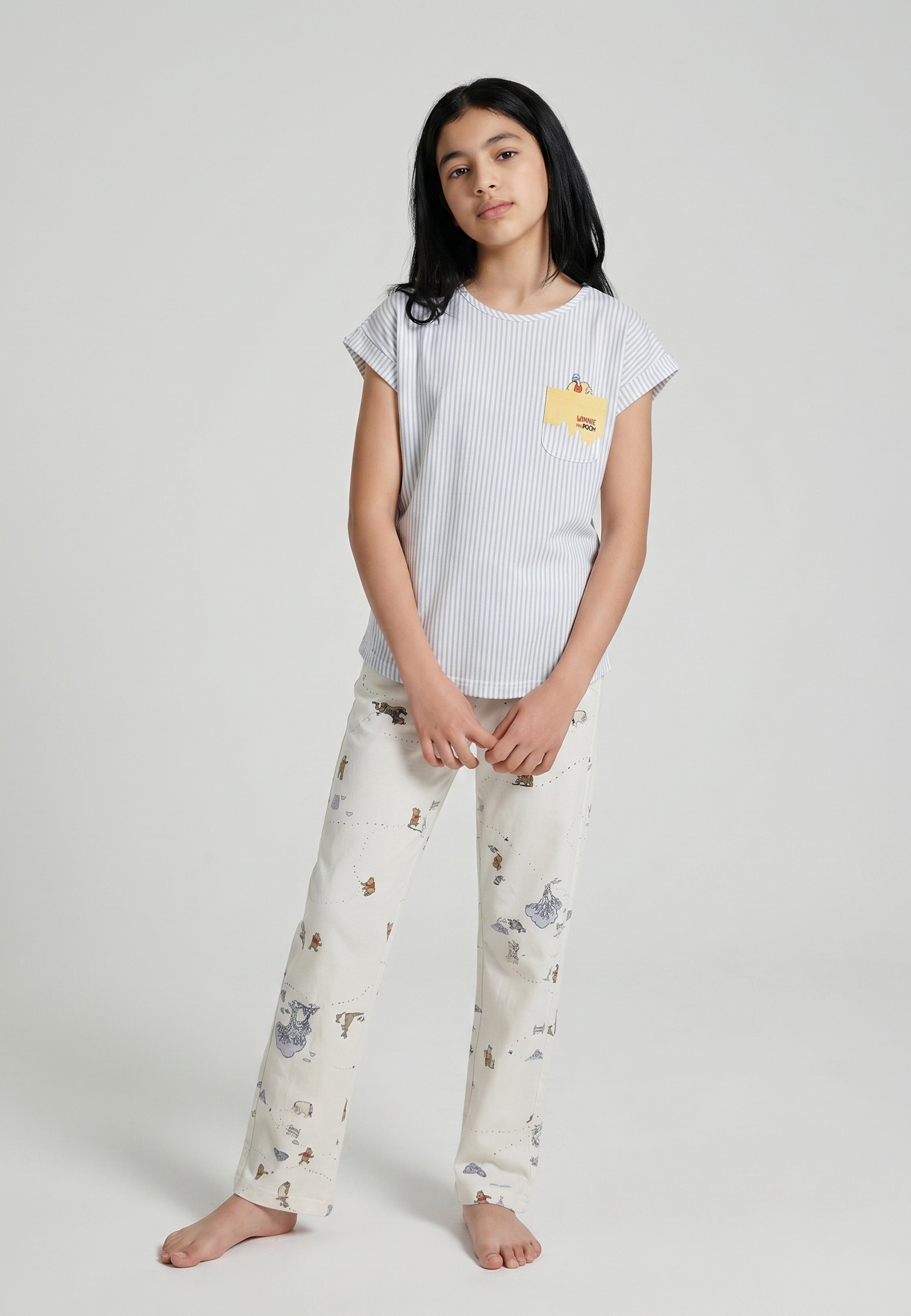 Adolescente portant un ensemble pyjama top col rond seersucker rayé bleu ciel poche patchée et pantalon imprimé fond crème Rosabella
