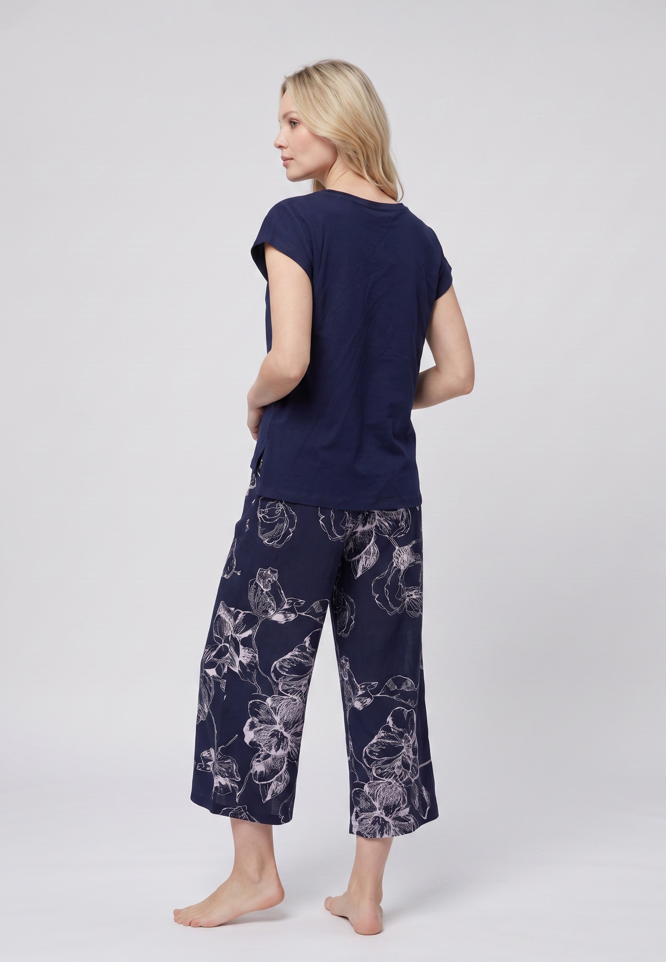 Pyjama pantacourt deux pièces T-shirt col rond bleu marine uni et pantacourt large fond marine imprimé grandes fleurs botaniques écru