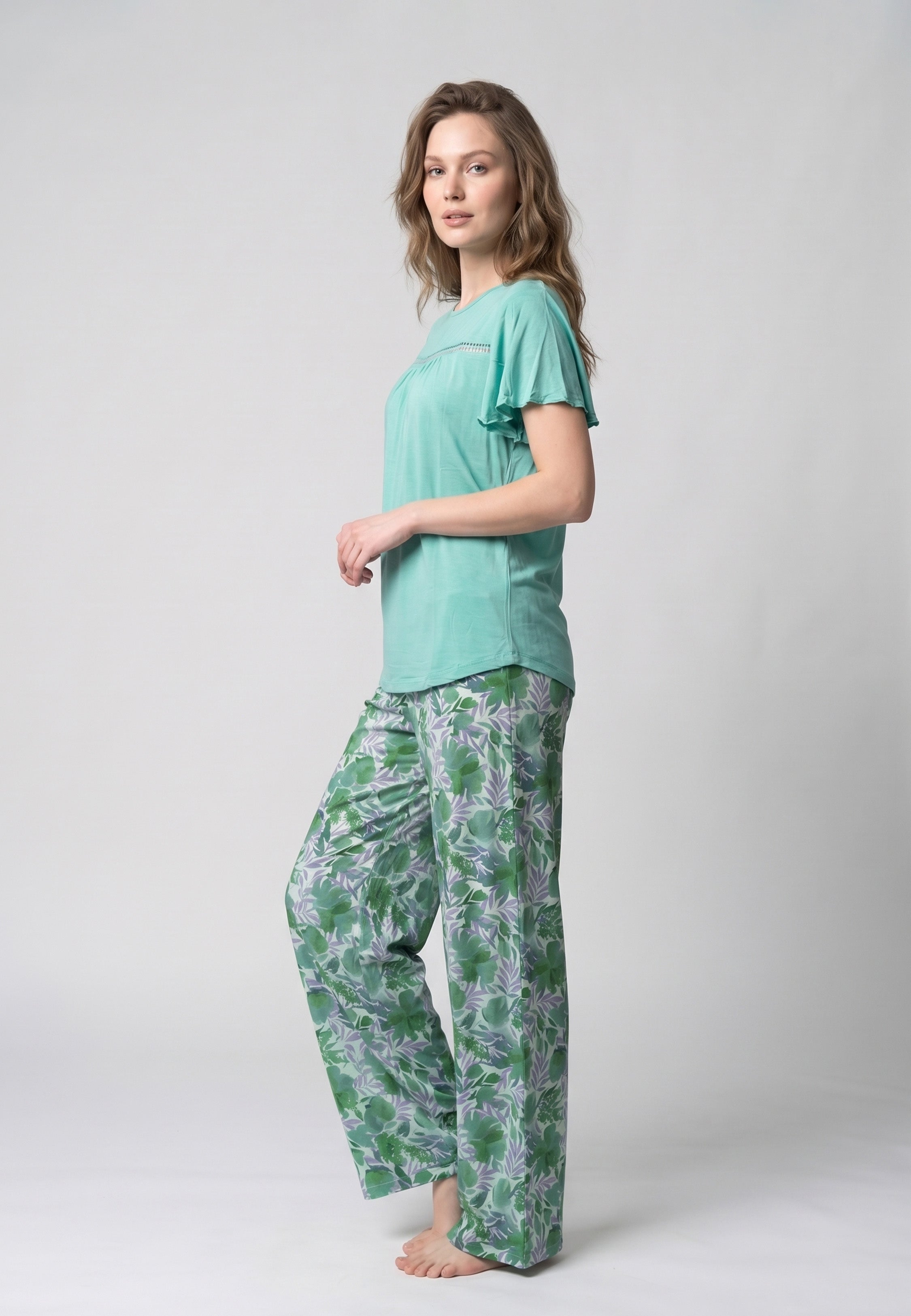 Femme portant un pyjama deux pièces t-shirt vert clair manches volantées broderie anglaise et pantalon large grand imprimé floral coloré Rosabella Juliet Rose