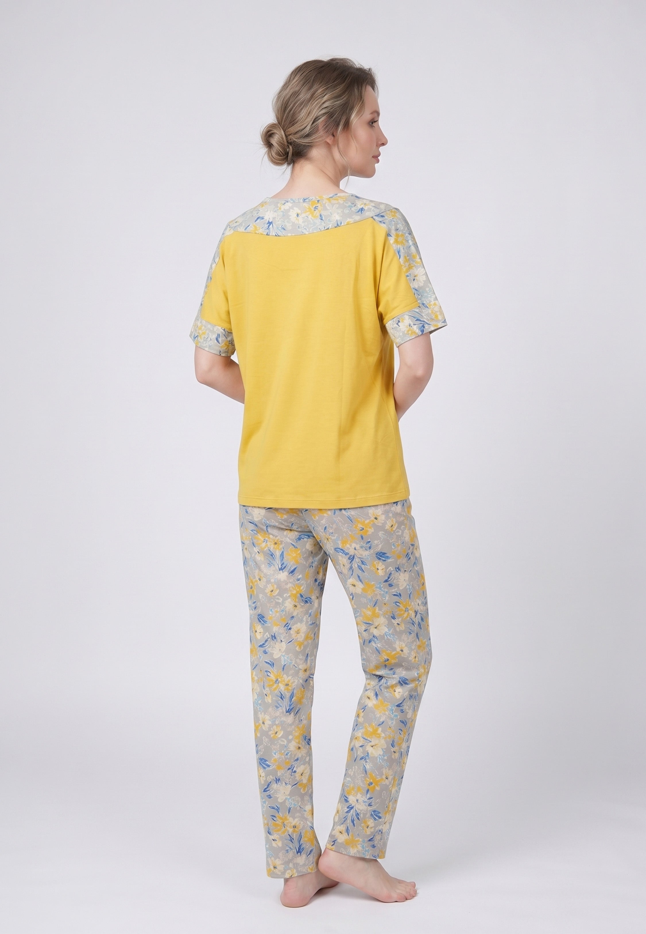 Femme portant un pyjama deux pièces t-shirt moutarde à empiècement fleuri et pantalon long imprimé ethnique floral jaune bleu et blanc Rosabella Ethnique 2