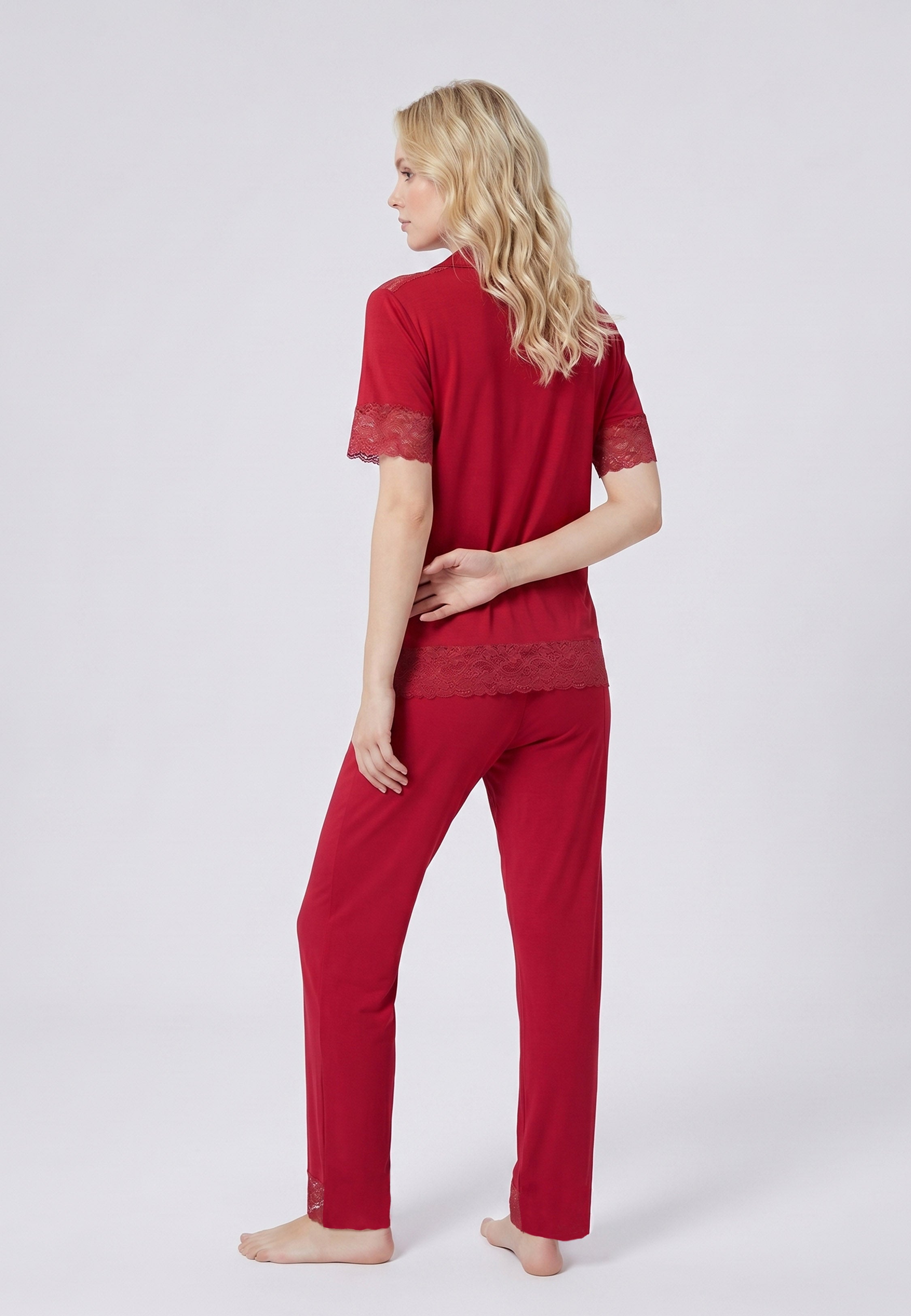Femme portant un pyjama deux pièces chemise boutonnée unie dentelle rouge et pantalon long uni dentelle aux chevilles Rosabella Chic Line