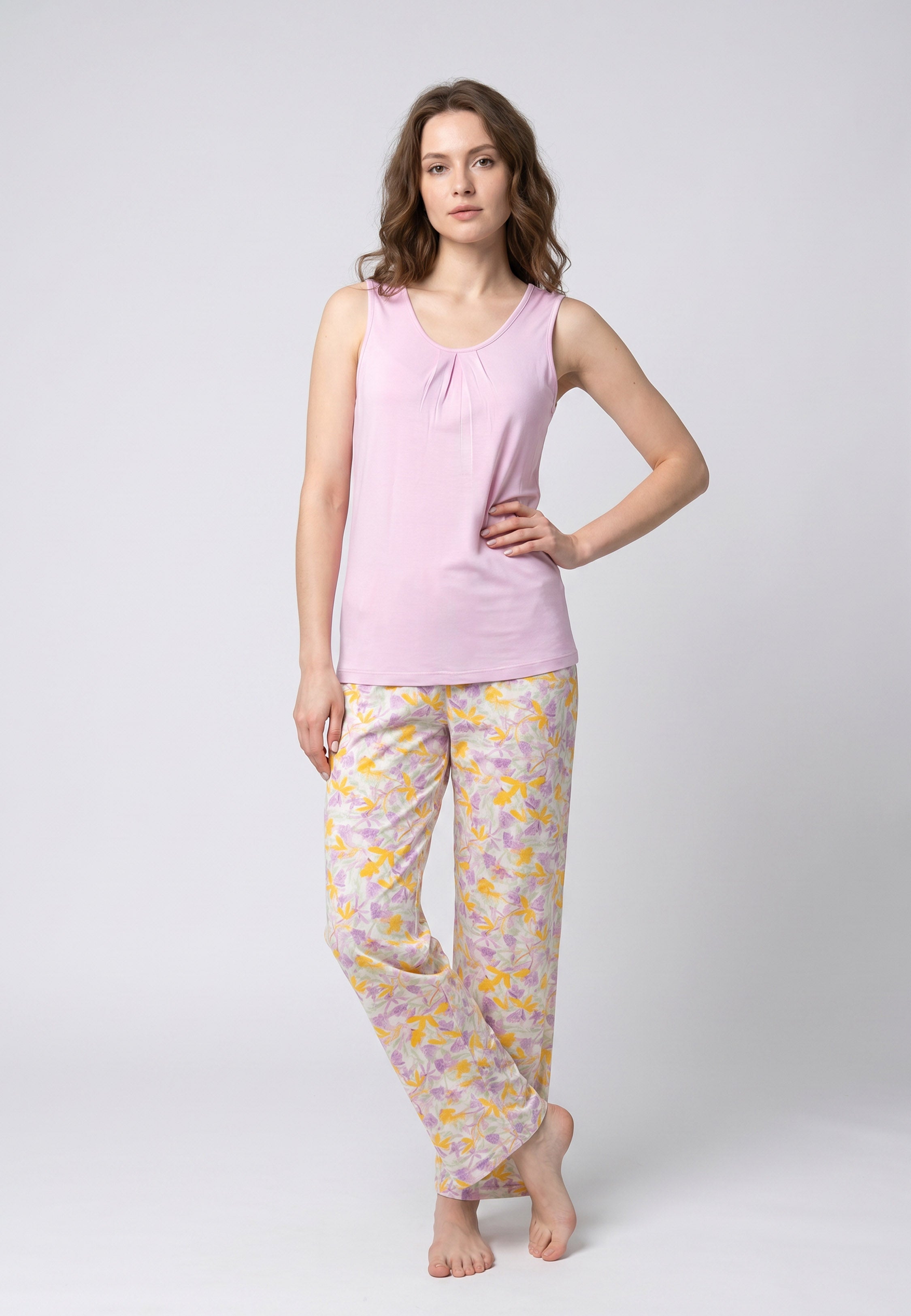 Femme portant un pyjama deux pièces débardeur col rond froncé uni mauve et pantalon long imprimé fleuri jaune mauve et vert Rosabella Chic Line