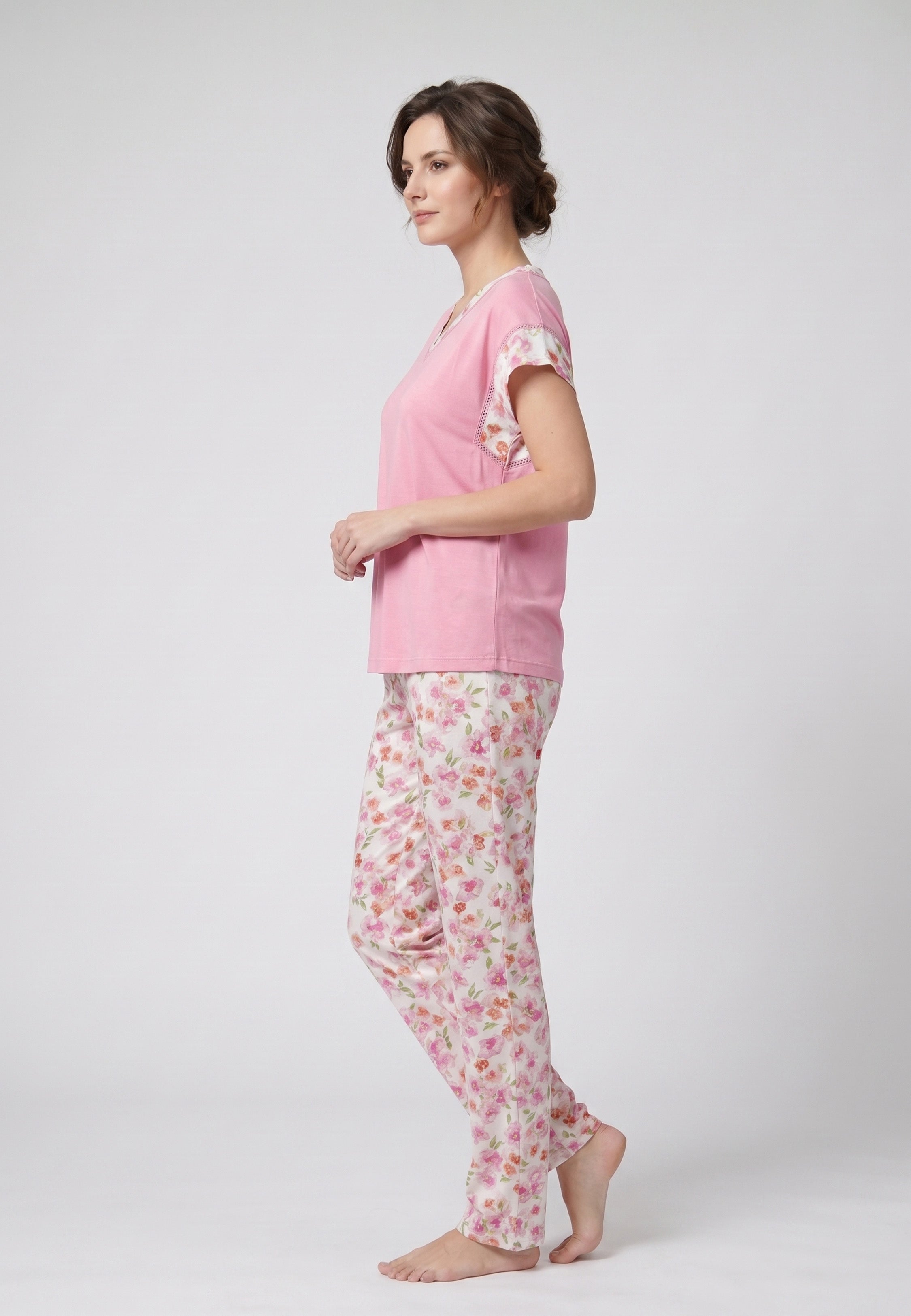 Femme portant un pyjama deux pièces t-shirt rose col V manches imprimé fleuri et pantalon long imprimé fleuri multicolore Rosabella Floralys