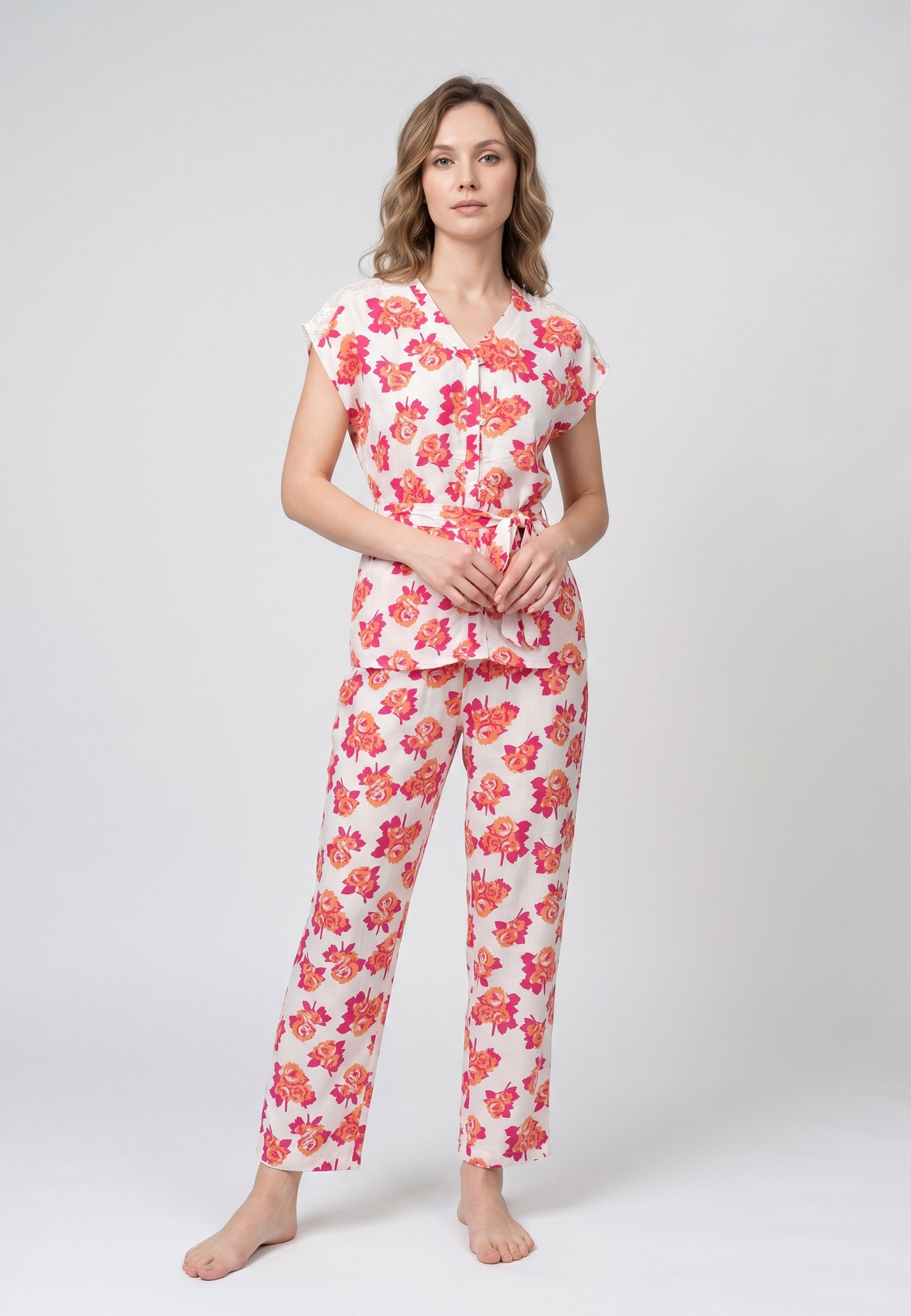 Femme portant un pyjama deux pièces blouse col V plissée imprimé fleuri multicolore orange et pantalon long assorti Rosabella Summer Time