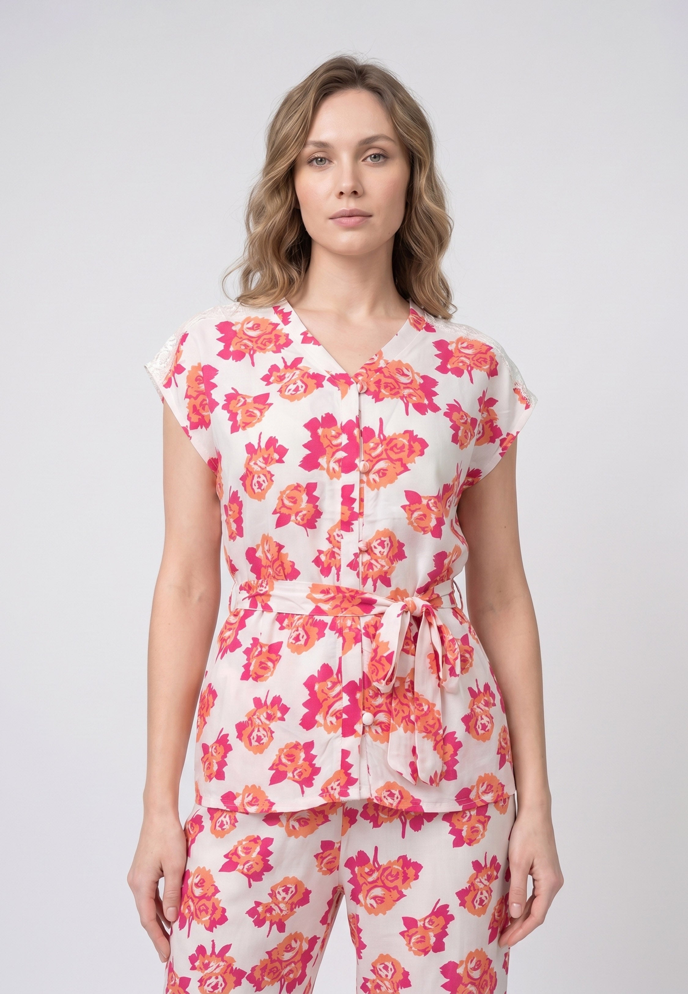Femme portant un pyjama deux pièces blouse col V plissée imprimé fleuri multicolore orange et pantalon long assorti Rosabella Summer Time