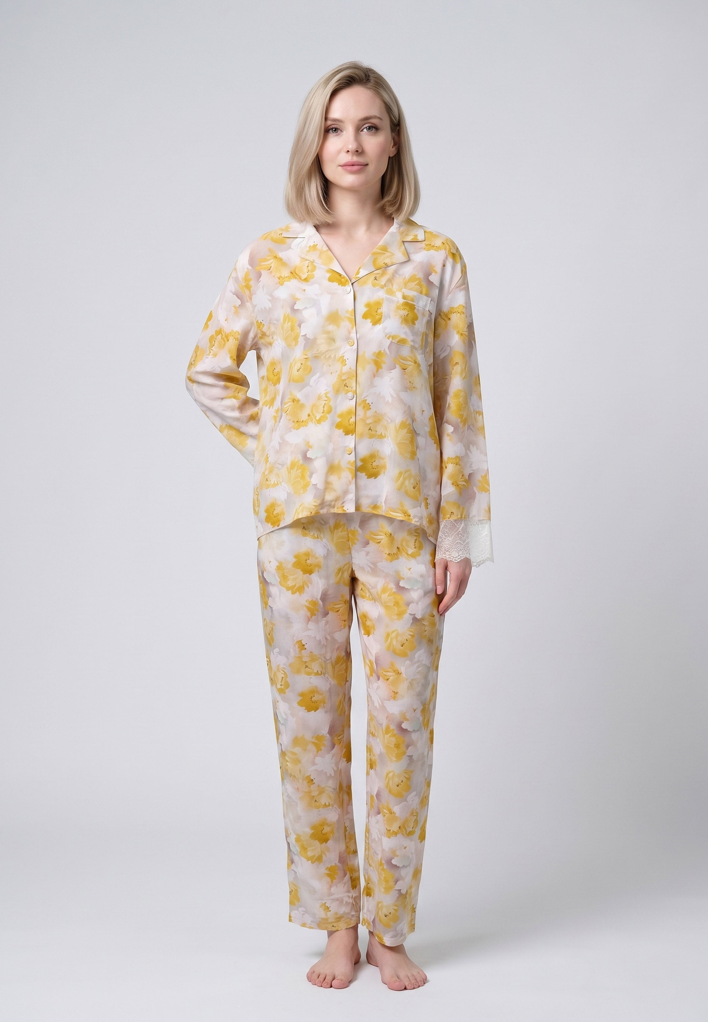 Femme portant un pyjama deux pièces chemise boutonnée manches longues dentelle imprimé fleuri aquarelle jaune et pantalon long assorti Rosabella Summer