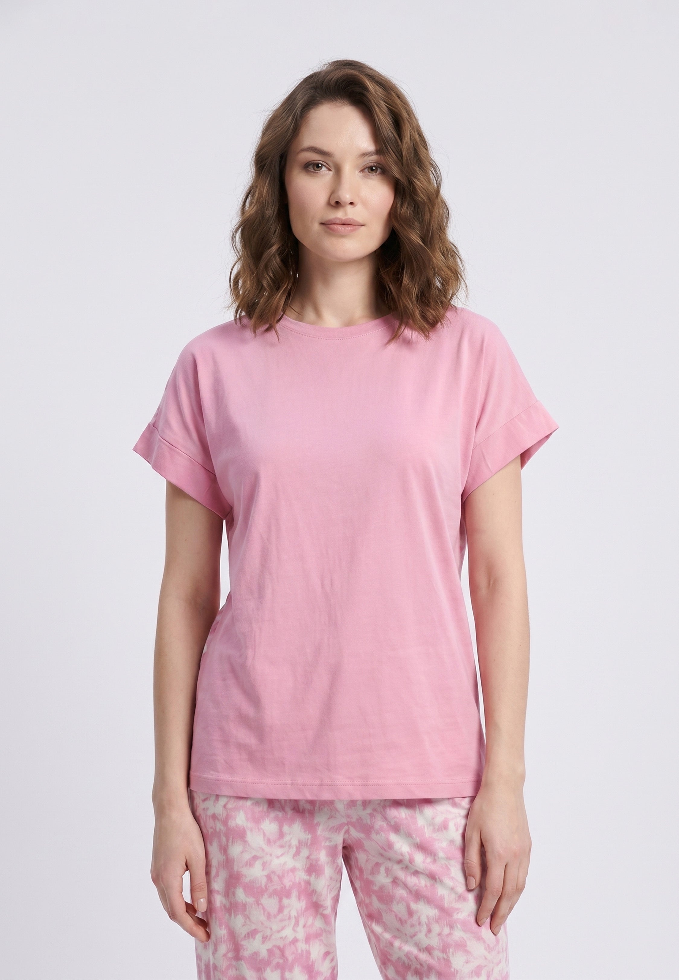 Femme portant un pyjama deux pièces t-shirt rose foncé uni et pantalon large imprimé aquarelle rose et blanc Rosabella Fleurs Sauvages