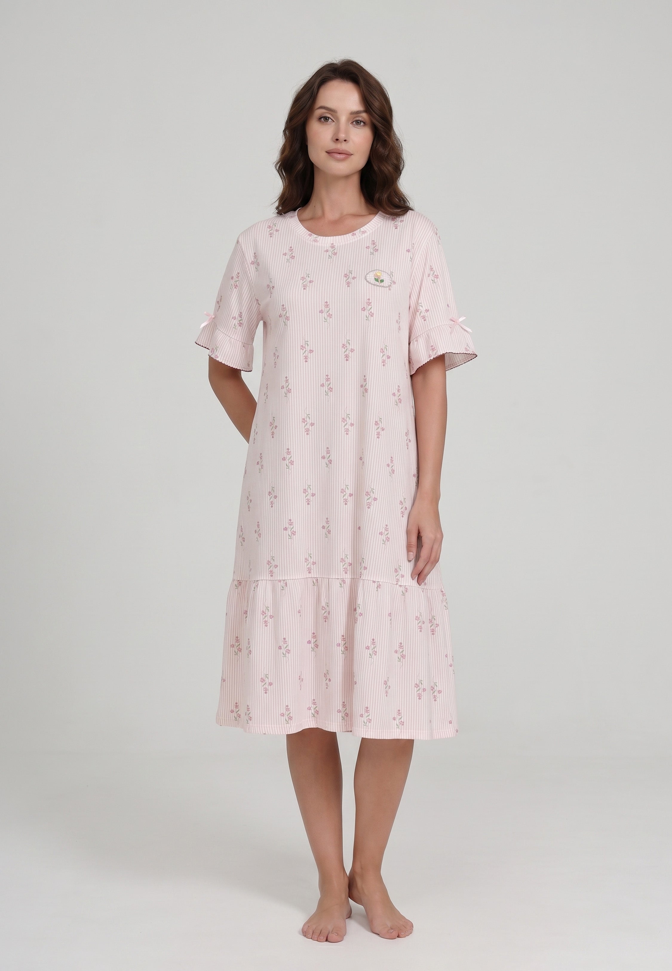 Femme portant une robe de nuit courte col rond manches courtes volantées ourlet volant imprimé rayé fleuri rose et blanc à petits motifs floraux badge brodé Rosabella Flowers Scent