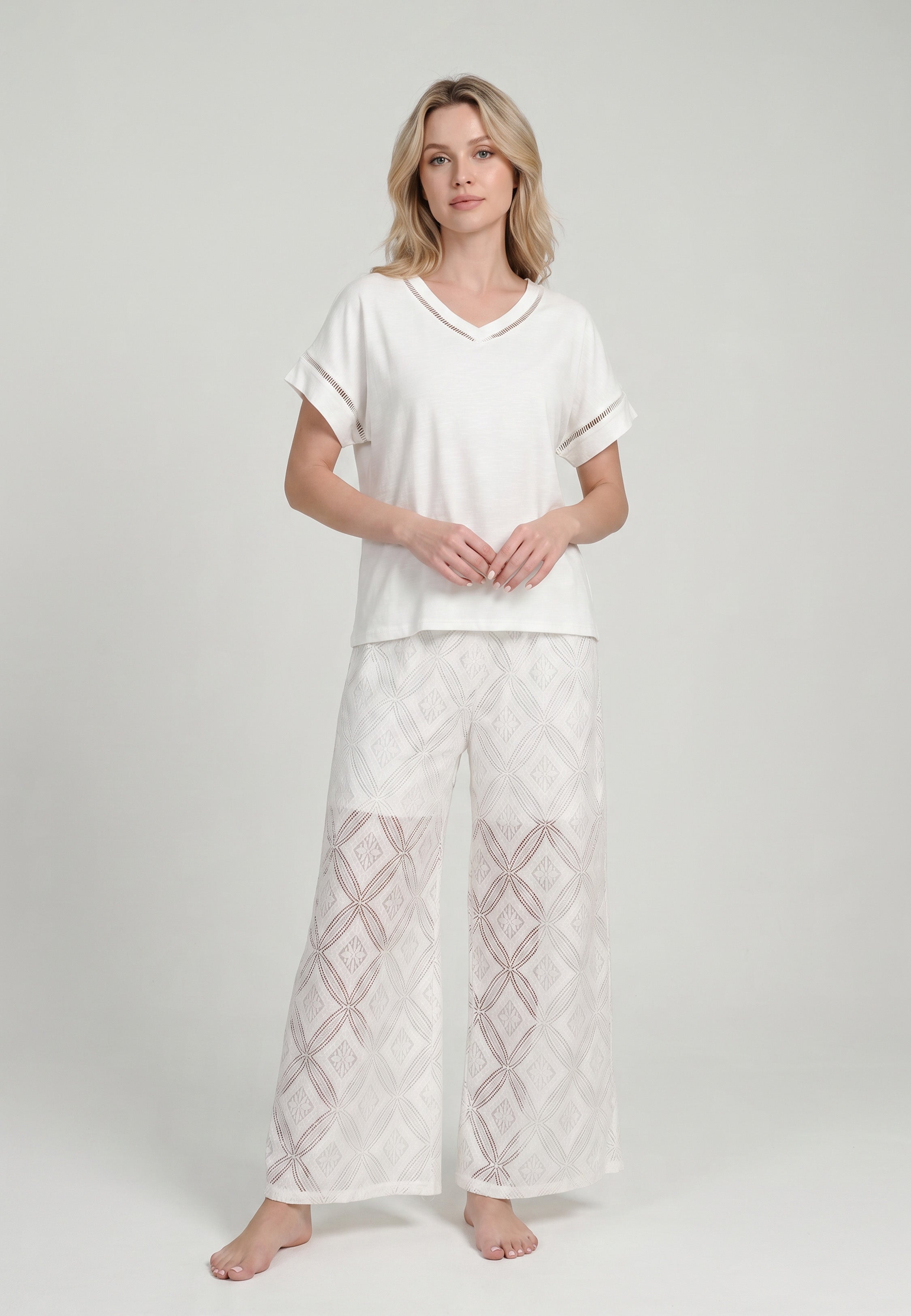 Femme portant un ensemble top col V oversize liseré ajouré et pantalon large broderie anglaise géométrique ivoire Rosabella